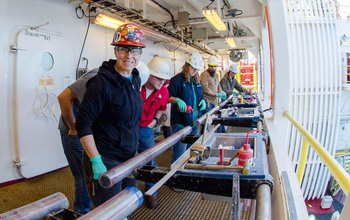 Zealandia on deck: a sediment core obtained through deep-sea drilling is pored over by scientists.